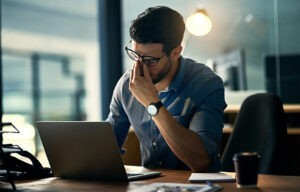 Man looking tired at work from sleep apnoea